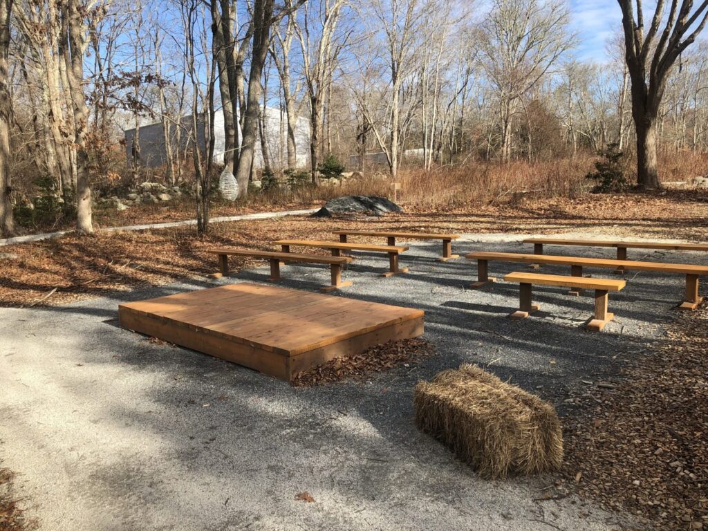 benches and stage in wooded area
